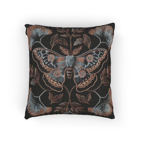 A square decorative pillow featuring an intricately detailed Luna moth in copper, terra cotta and slate blue colors on a black background. The moth is centered in a symmetrical arrangement with ginkgo-inspired leaves and botanical elements surrounding it.